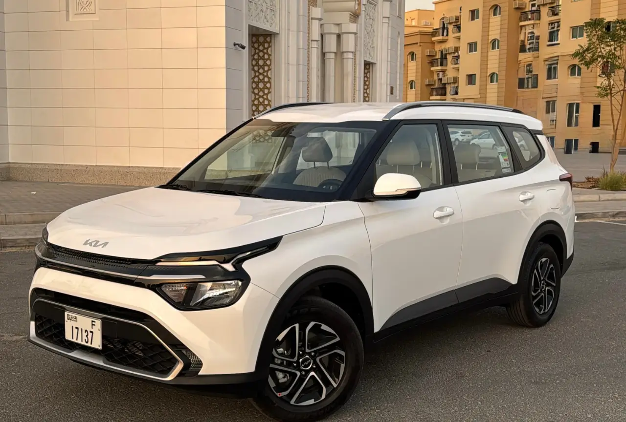 White 2025 Kia Carens shown from the front side in Dubai