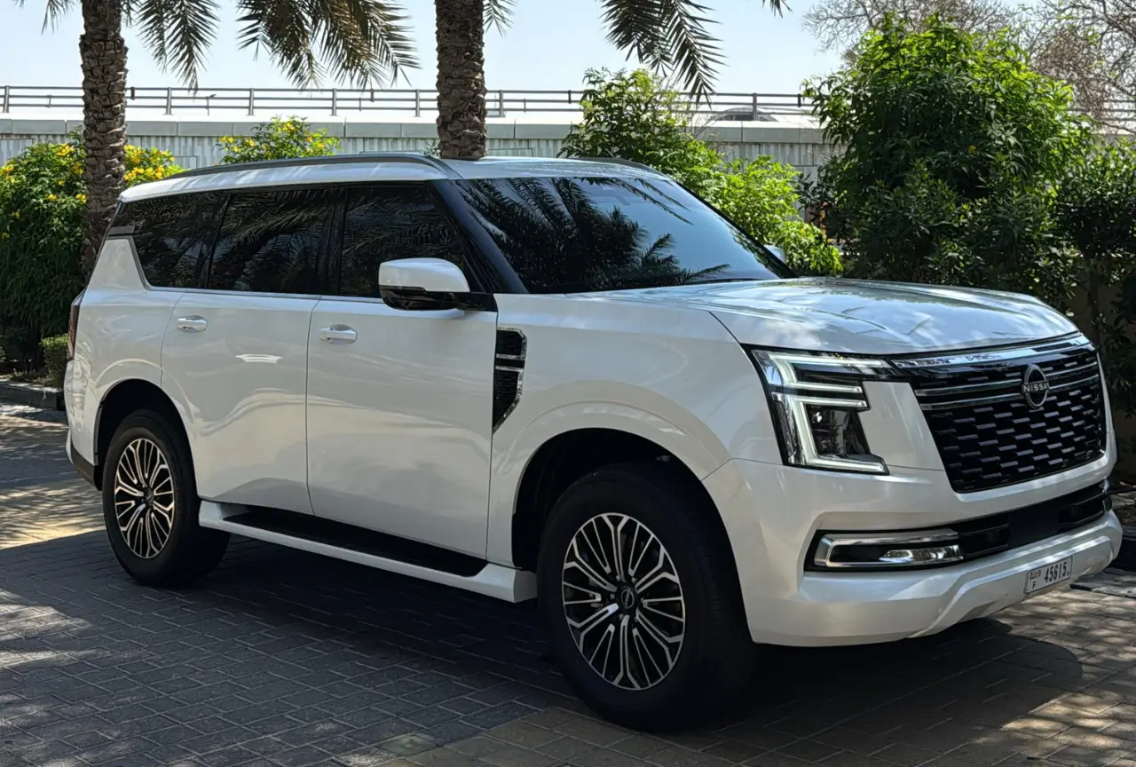 Nissan Patrol Platinum dashboard with digital displays and burgundy interior