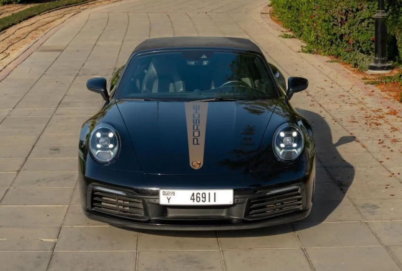 Black Porsche 911 Cabriolet side profile in Dubai