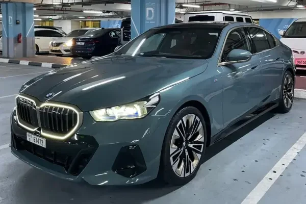 Grey BMW 5 Series sedan parked in a Dubai garage