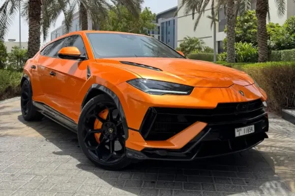 Orange Lamborghini Urus parked outside a modern Dubai villa