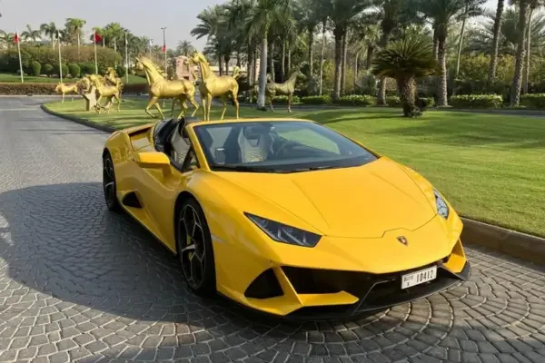 Yellow Lamborghini Evo parked outside a luxury estate in Dubai